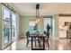 This bright dining room features a modern light fixture and plenty of natural light from a large sliding glass door at 17859 E 108Th Pl, Commerce City, CO 80022