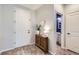 Inviting entryway featuring modern décor and access to a nearby bathroom, creating a welcoming ambiance at 17859 E 108Th Pl, Commerce City, CO 80022