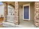 Charming front porch with stone columns and a welcoming entrance to the home at 17859 E 108Th Pl, Commerce City, CO 80022