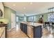 Modern kitchen features a central island with a stainless steel dishwasher, a sink, and granite countertops at 17859 E 108Th Pl, Commerce City, CO 80022