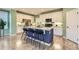Modern kitchen with a central island, granite countertops, and white cabinets, creating a stylish cooking space at 17859 E 108Th Pl, Commerce City, CO 80022