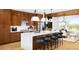Open kitchen featuring an island with bar seating, stainless steel appliances, and wood cabinetry at 10886 E Hinsdale Cir, Centennial, CO 80112