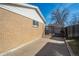 This side yard has a brick home, a shed, and a black fence at 3288 W Tufts Ave, Englewood, CO 80110
