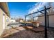 This backyard features a patio table under a pergola near the backyard shed at 3288 W Tufts Ave, Englewood, CO 80110
