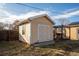 This backyard features a small storage shed with a white crossbuck door at 3288 W Tufts Ave, Englewood, CO 80110