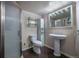 This bathroom features a pedestal sink, tiled flooring, a shower, and a mirrored cabinet at 3288 W Tufts Ave, Englewood, CO 80110