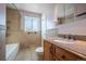 Traditional bathroom with tiled walls and floors, granite counters, and shower-tub combo at 3288 W Tufts Ave, Englewood, CO 80110