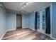 This bedroom features laminate flooring, a closet, French doors with curtains, and neutral paint at 3288 W Tufts Ave, Englewood, CO 80110