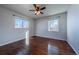 This is a light-filled bedroom with hardwood floors and natural light from the windows at 3288 W Tufts Ave, Englewood, CO 80110