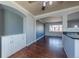 Open-concept dining room connected to the kitchen with hardwood floors and modern design at 3288 W Tufts Ave, Englewood, CO 80110