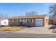Charming brick home featuring an attached garage and a well-maintained front yard on a sunny day at 3288 W Tufts Ave, Englewood, CO 80110