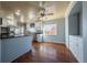 Open concept kitchen and dining area featuring white cabinets and stainless steel appliances at 3288 W Tufts Ave, Englewood, CO 80110