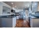 Well-lit kitchen featuring granite countertops, stainless steel appliances, and white cabinetry at 3288 W Tufts Ave, Englewood, CO 80110