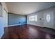 Bright and airy living room featuring beautiful hardwood floors and a large window at 3288 W Tufts Ave, Englewood, CO 80110