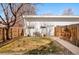 Private backyard featuring a small lawn, wooden fence, planting area, and modern building at 1333 Raleigh St, Denver, CO 80204