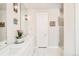 Bright bathroom with dual sinks, white cabinets, and large mirrors at 1333 Raleigh St, Denver, CO 80204