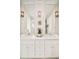 Bathroom with dual sinks, white cabinets and marble floors at 1333 Raleigh St, Denver, CO 80204