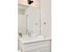 Bright bathroom featuring a white vanity with chrome faucet, large mirror, and modern lighting fixture at 1333 Raleigh St, Denver, CO 80204