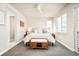 Bright bedroom with a ceiling fan, large window and ensuite bathroom at 1333 Raleigh St, Denver, CO 80204