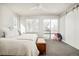 Spacious bedroom with light gray carpet, a bench, and two windows overlooking the backyard at 1333 Raleigh St, Denver, CO 80204