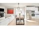 Open-concept dining area next to modern kitchen and living room with fireplace at 1333 Raleigh St, Denver, CO 80204