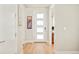 Bright entryway with hardwood floors and a modern front door with frosted glass panels at 1333 Raleigh St, Denver, CO 80204
