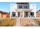 Modern duplex with xeriscaped front yard, concrete steps, and covered porches featuring a red door at 1333 Raleigh St, Denver, CO 80204