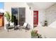 Inviting front porch with stone accent wall, seating area, and a vibrant red front door at 1333 Raleigh St, Denver, CO 80204