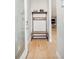 Welcoming hallway with light wood floors and a modern hall tree with a bench and storage at 1333 Raleigh St, Denver, CO 80204