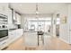 Modern kitchen with white cabinets, stainless steel appliances, and large windows overlooking the backyard at 1333 Raleigh St, Denver, CO 80204