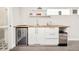 Kitchenette features a modern countertop, white cabinets, and stainless steel appliances at 1333 Raleigh St, Denver, CO 80204