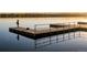 Beautiful still shot of a person fishing from a wooden pier with calm waters in Sloan's Lake at 1333 Raleigh St, Denver, CO 80204