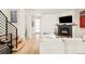 Cozy living room features a fireplace, modern staircase, and hardwood floors at 1333 Raleigh St, Denver, CO 80204