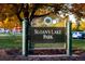 Sloan's Lake Park sign amidst autumn colors with lush greenery and blue sky at 1333 Raleigh St, Denver, CO 80204