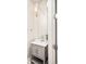 Stylish powder room featuring a gray vanity, sconce lighting, and a large mirror at 1333 Raleigh St, Denver, CO 80204