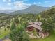Aerial view of mountain home surrounded by mature landscaping at 127 Granite Way, Evergreen, CO 80439