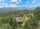 Mountain home surrounded by mature trees with beautiful mountain views at 127 Granite Way, Evergreen, CO 80439