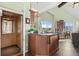 Wet bar area with counter seating and wooden cabinets next to a wood paneled elevator at 127 Granite Way, Evergreen, CO 80439