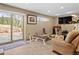 Basement gym with weight machines, tv, and access to backyard patio at 127 Granite Way, Evergreen, CO 80439