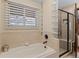 Bright bathroom features a soaking tub, glass enclosed shower, and plenty of natural light at 127 Granite Way, Evergreen, CO 80439