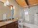 Bathroom featuring a glass shower enclosure and wood ceiling beams at 127 Granite Way, Evergreen, CO 80439