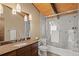 Stylish bathroom with a glass-enclosed shower and vanity with wooden cabinets at 127 Granite Way, Evergreen, CO 80439