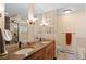Bathroom featuring a double vanity with granite countertops and a glass block accent wall at 127 Granite Way, Evergreen, CO 80439