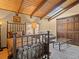 Bedroom with wood ceiling beams and skylight at 127 Granite Way, Evergreen, CO 80439