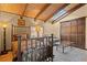 Inviting bedroom with wood beam ceilings and a cozy seating area at 127 Granite Way, Evergreen, CO 80439