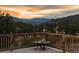 Scenic deck view overlooking lush greenery and distant mountains, perfect for outdoor relaxation at 127 Granite Way, Evergreen, CO 80439