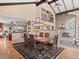 Open-concept dining room adjacent to the kitchen, featuring a rustic table set and views of the living area at 127 Granite Way, Evergreen, CO 80439