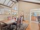 Elegant dining area with a wooden table, comfortable leather chairs, stylish lighting, and a view of the kitchen at 127 Granite Way, Evergreen, CO 80439