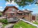 Back exterior of a home featuring wood deck, stone accents, and landscaping at 127 Granite Way, Evergreen, CO 80439