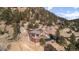 Beautiful home nestled in the mountains with a unique design and surrounding greenery at 127 Granite Way, Evergreen, CO 80439